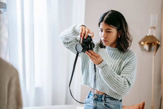 person shooting photo on photo camera