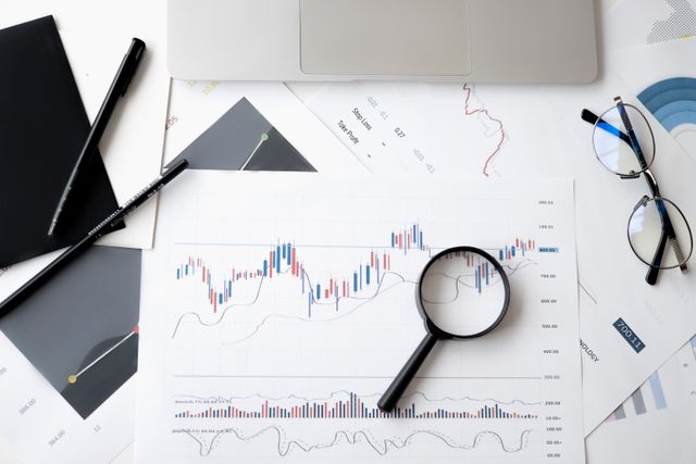market analysis documents with magnifying glass